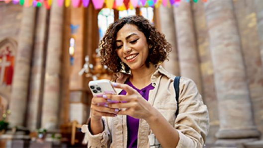 Image of woman on phone outside of church
